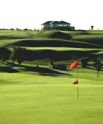 Gort Golf Club - 1st green with 9th geen and clubhouse in the background